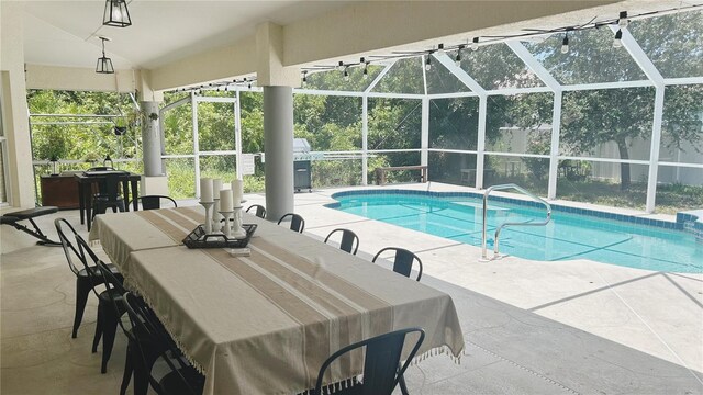 view of pool featuring a patio area and glass enclosure