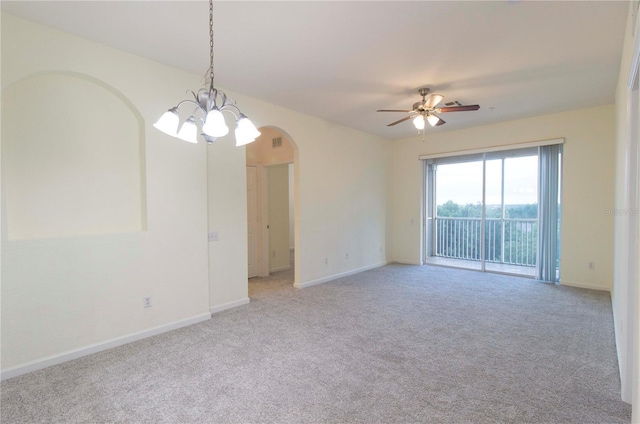 carpeted empty room with ceiling fan with notable chandelier