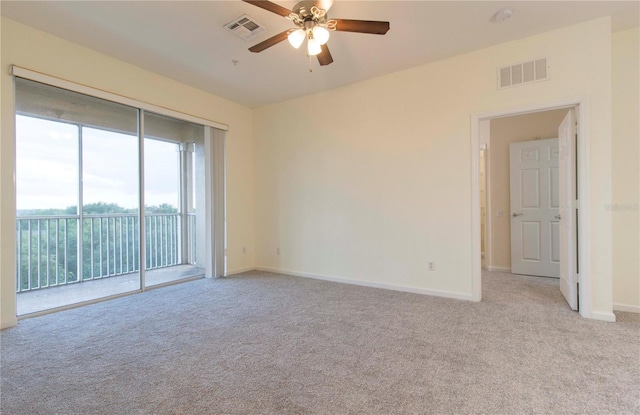 carpeted empty room featuring ceiling fan