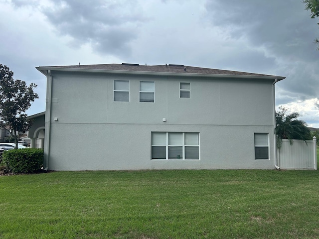 rear view of house with a yard