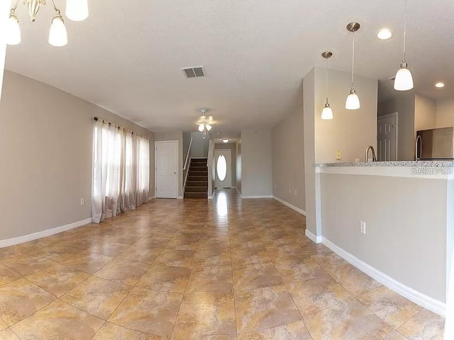 unfurnished living room featuring light tile floors