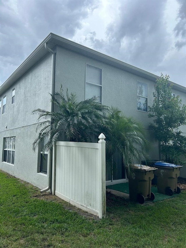 view of property exterior with a lawn