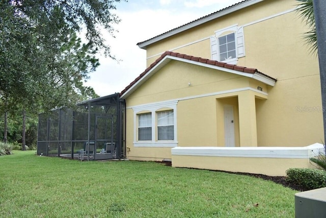 view of side of home with a lawn