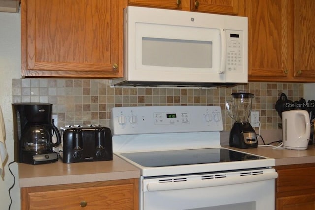 kitchen with white appliances and tasteful backsplash