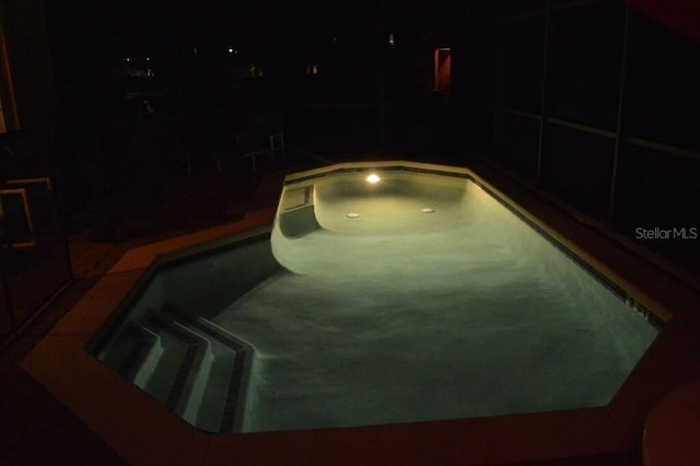 view of pool at night