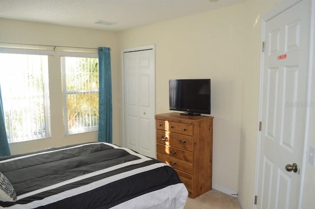 bedroom featuring carpet and a closet