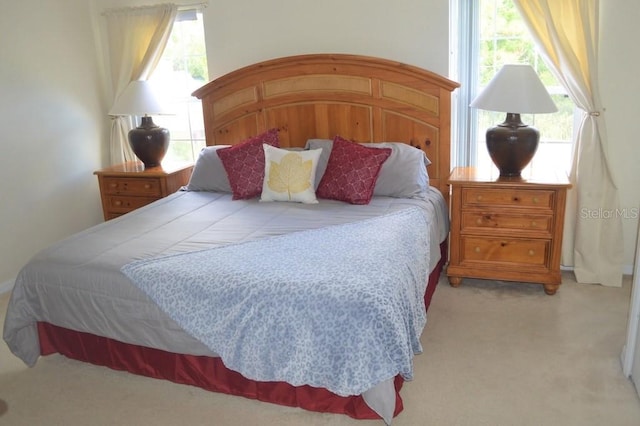 carpeted bedroom with multiple windows