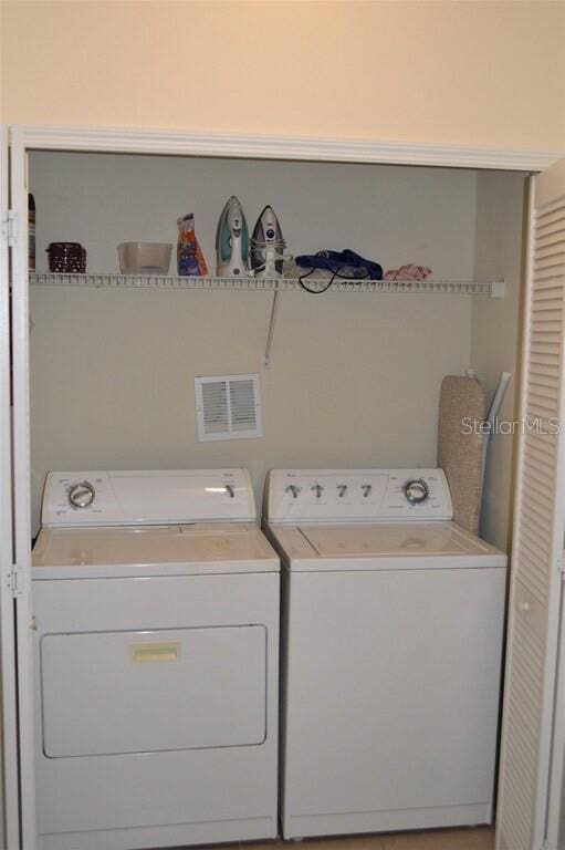 clothes washing area featuring washing machine and dryer