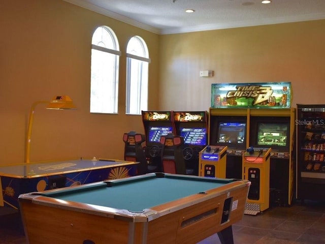 recreation room with dark tile flooring, ornamental molding, and pool table