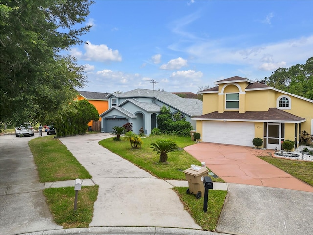 view of front of home with a front yard and a garage