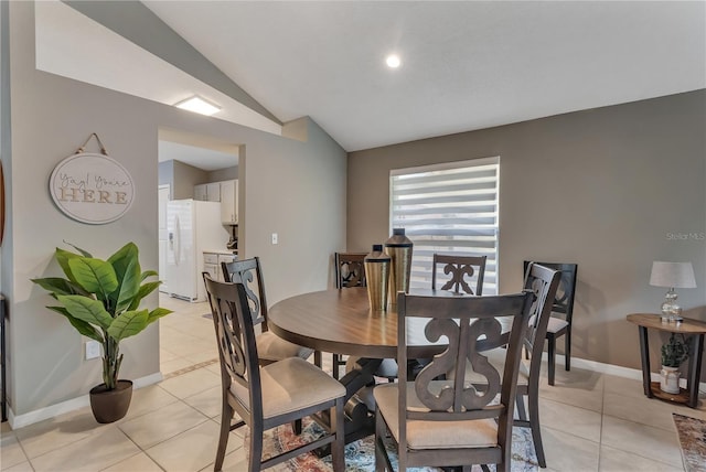 dining space featuring light tile patterned floors and lofted ceiling