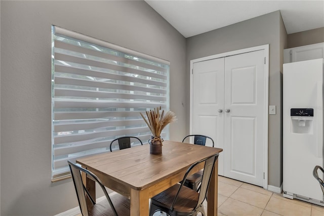 dining space featuring light tile patterned floors