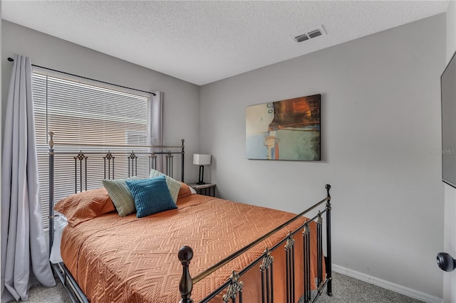 carpeted bedroom with a textured ceiling