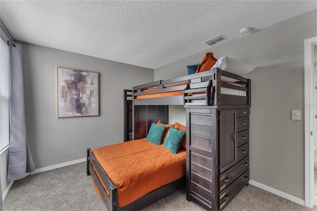 carpeted bedroom featuring a textured ceiling