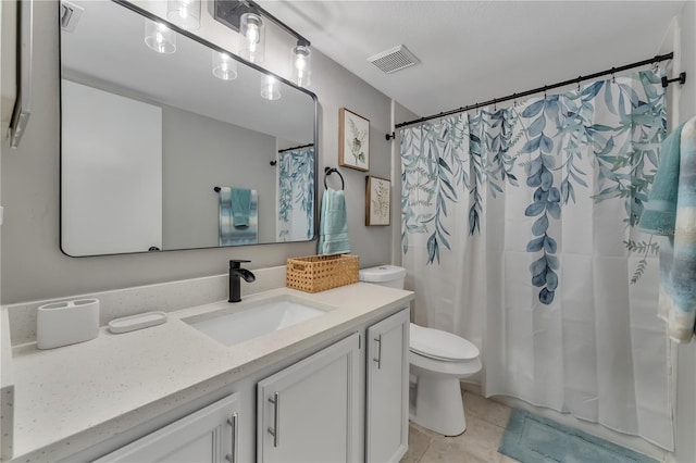 bathroom featuring tile patterned floors, vanity, a shower with shower curtain, and toilet