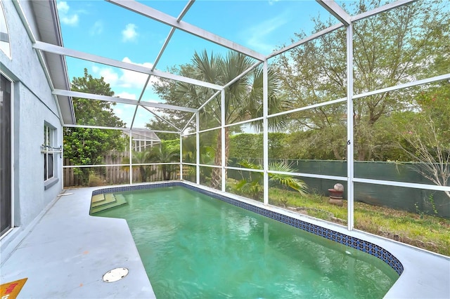 view of swimming pool with a lanai