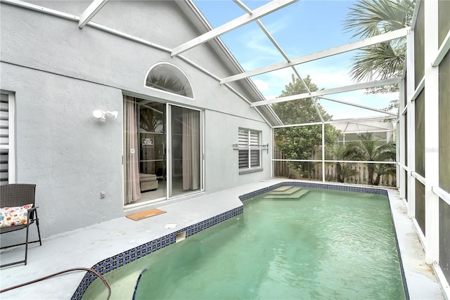 view of swimming pool featuring a lanai