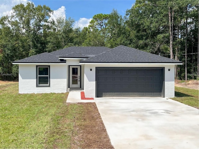 view of front of home featuring a garage and a front yard