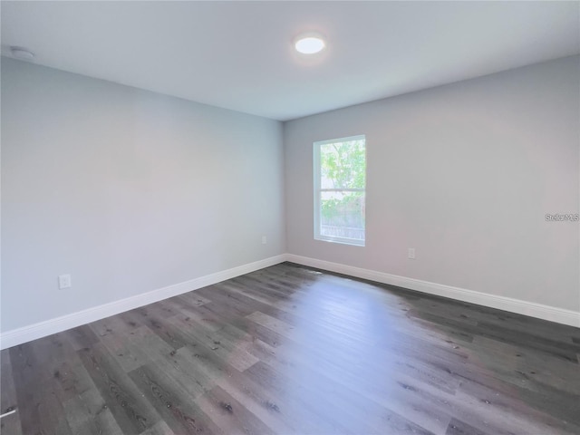 empty room featuring dark wood-type flooring