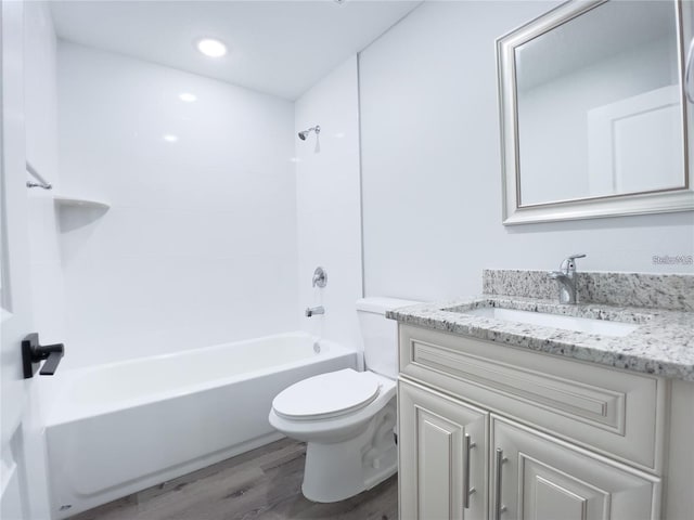 full bathroom with bathing tub / shower combination, vanity, toilet, and hardwood / wood-style floors