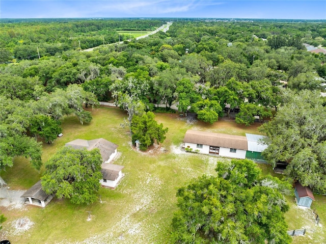 drone / aerial view featuring a wooded view