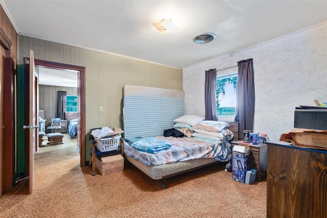 bedroom featuring visible vents, carpet flooring, and ornamental molding