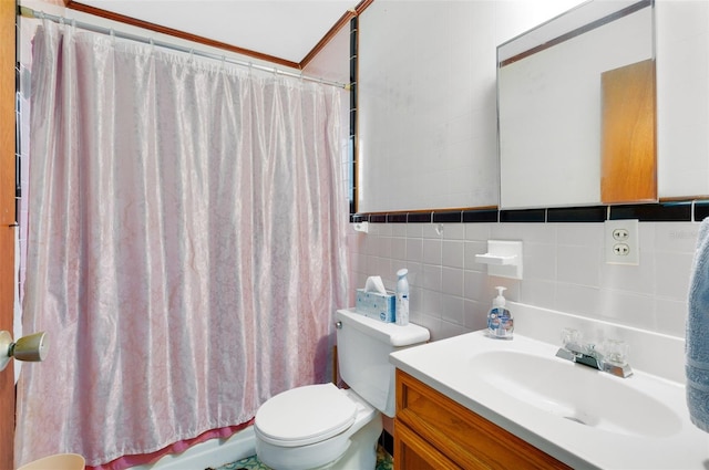 bathroom featuring toilet, vanity, and tile walls