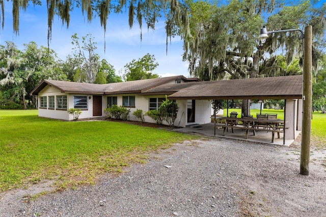 ranch-style home with a front lawn