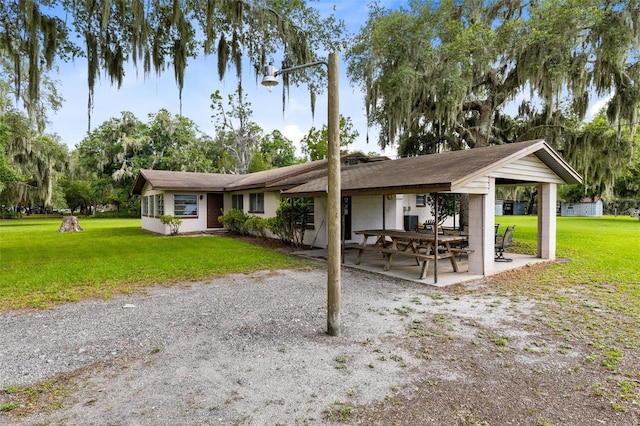 view of community featuring a yard and a patio