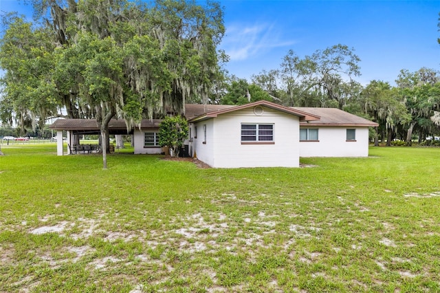 back of property featuring a lawn