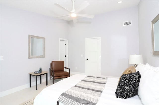 bedroom with ceiling fan and a towering ceiling