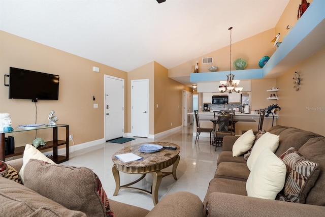 tiled living room with a notable chandelier and high vaulted ceiling