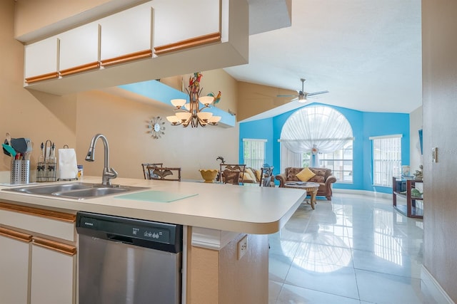 kitchen with dishwasher, ceiling fan with notable chandelier, light tile floors, sink, and lofted ceiling