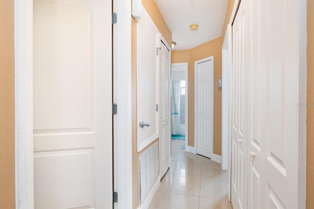 corridor with light tile flooring