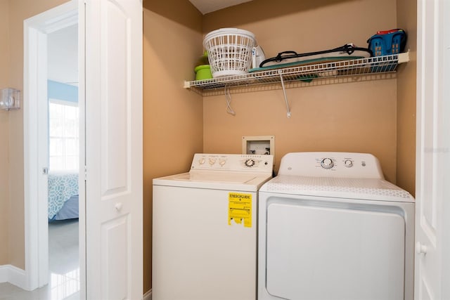 washroom featuring washer and dryer, tile flooring, and washer hookup