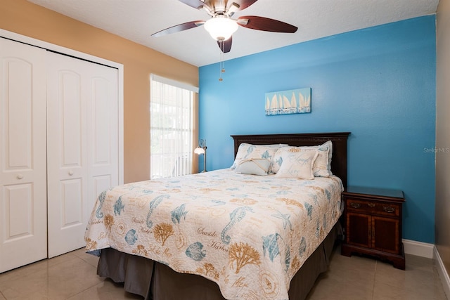 bedroom featuring tile floors, a closet, and ceiling fan