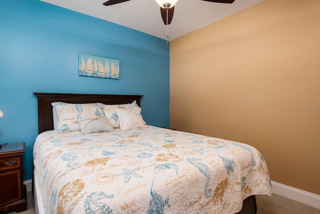 bedroom with ceiling fan and a textured ceiling