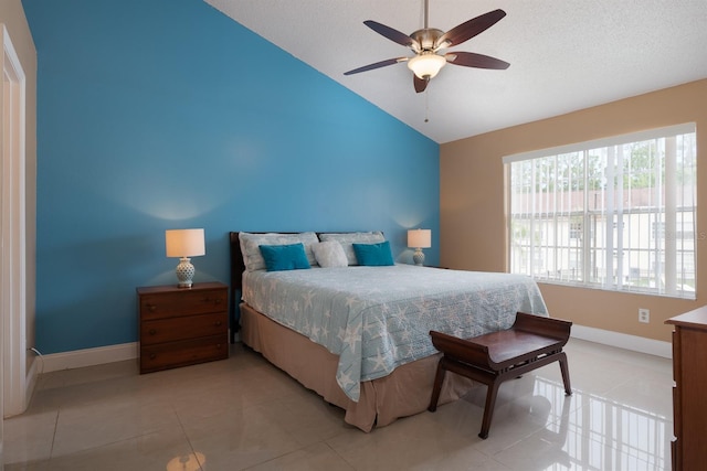 bedroom with ceiling fan, light tile flooring, and lofted ceiling