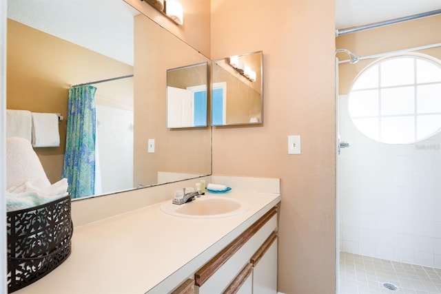 bathroom featuring oversized vanity and walk in shower