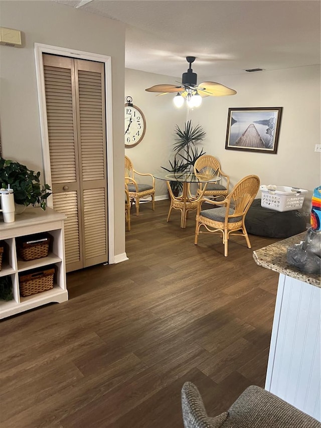 dining space featuring dark hardwood / wood-style flooring and ceiling fan