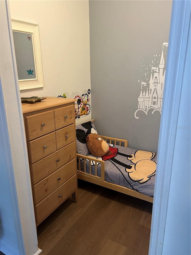 bedroom with dark wood-type flooring