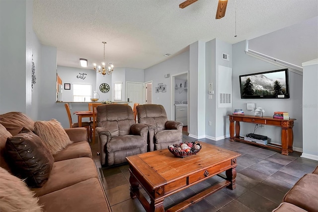 living room with ceiling fan with notable chandelier and a textured ceiling