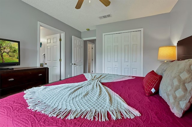 bedroom featuring a textured ceiling, a closet, and ceiling fan