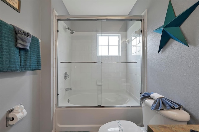 full bathroom with vanity, shower / bath combination with glass door, and toilet