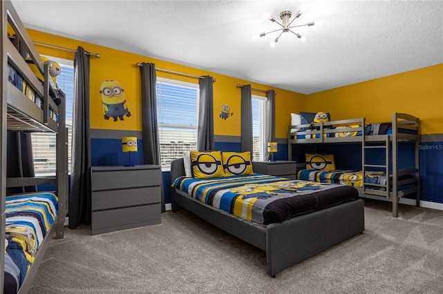 bedroom with carpet, a textured ceiling, and an inviting chandelier