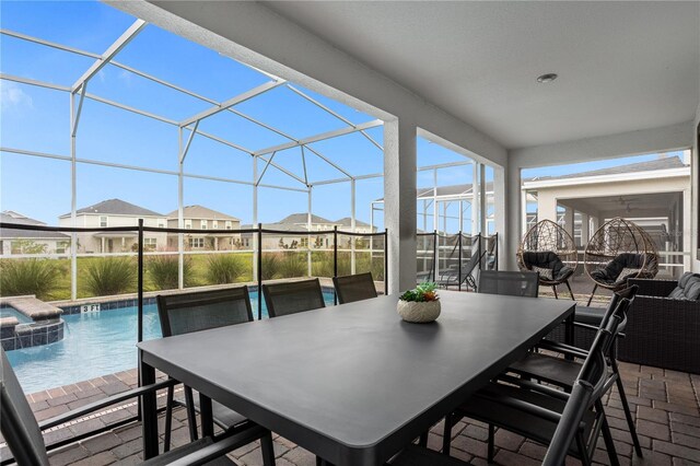 view of patio featuring a swimming pool with hot tub and a lanai