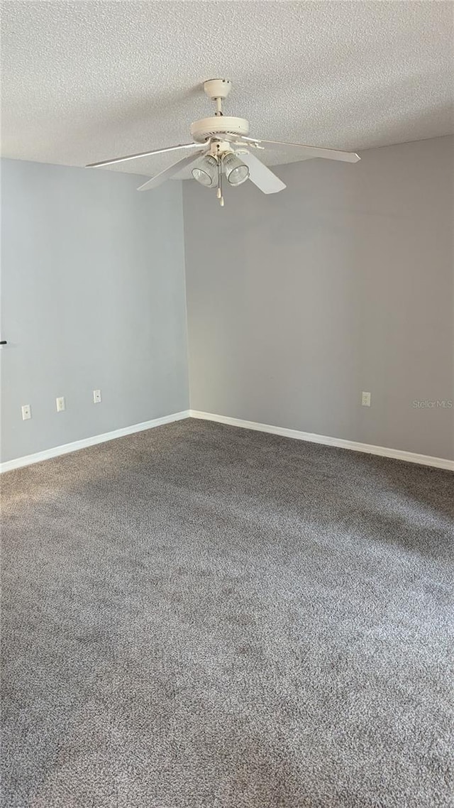 carpeted spare room with a textured ceiling and ceiling fan