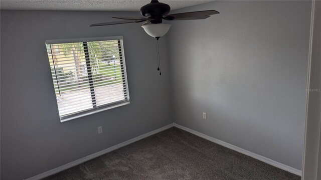 carpeted spare room featuring a textured ceiling and ceiling fan