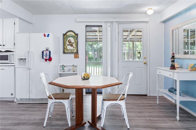 dining space with dark hardwood / wood-style floors