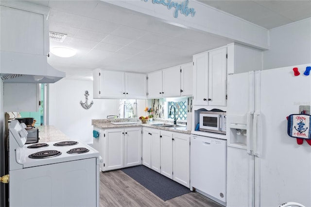 kitchen featuring white cabinetry, sink, wood-type flooring, and white appliances